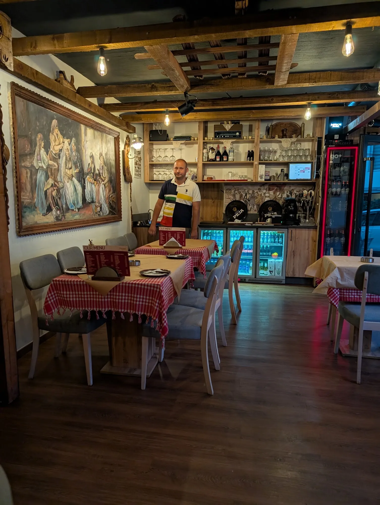 The dining room and bar with red-checked tables