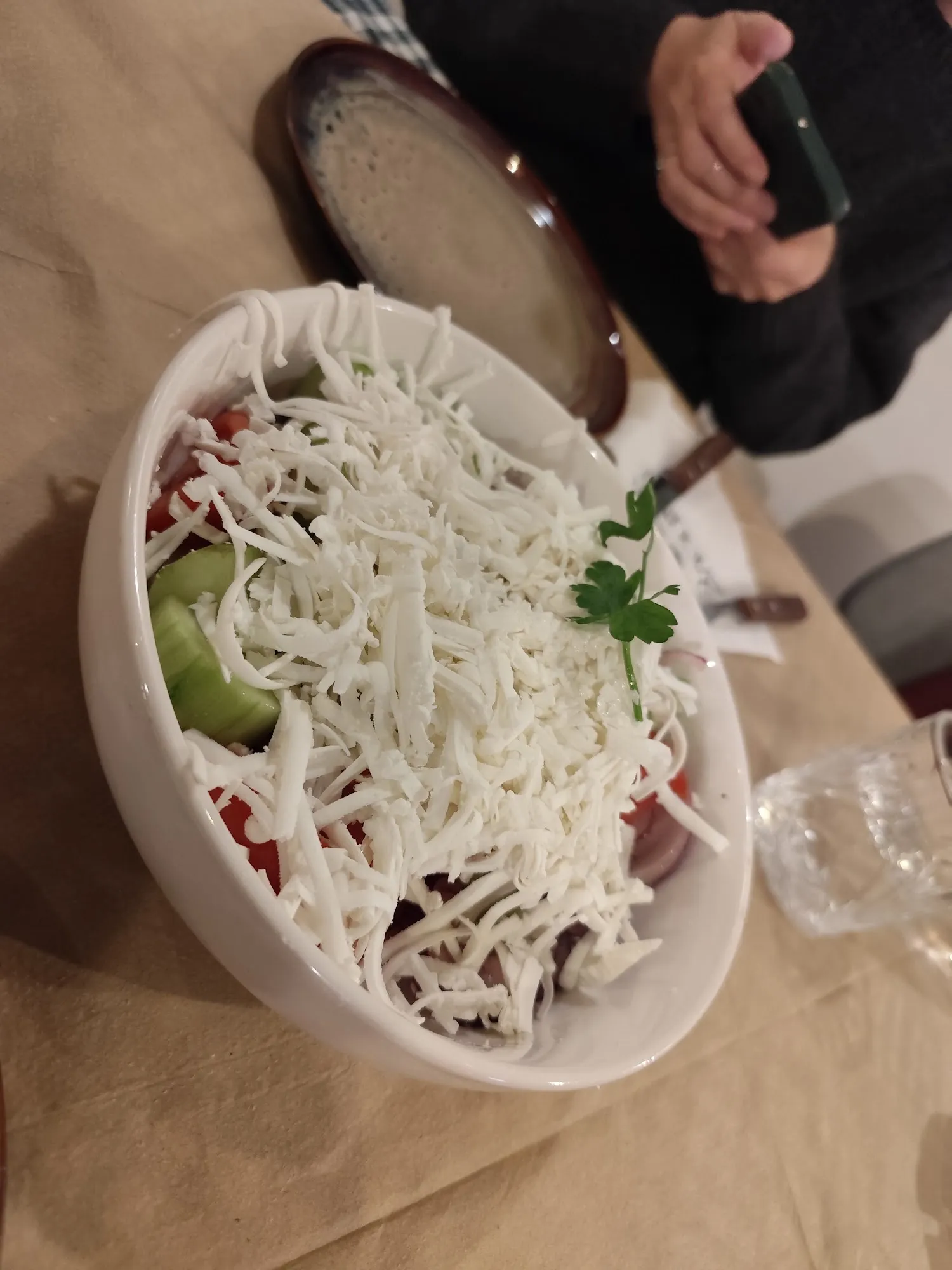 Shopska salad heaped with grated white cheese